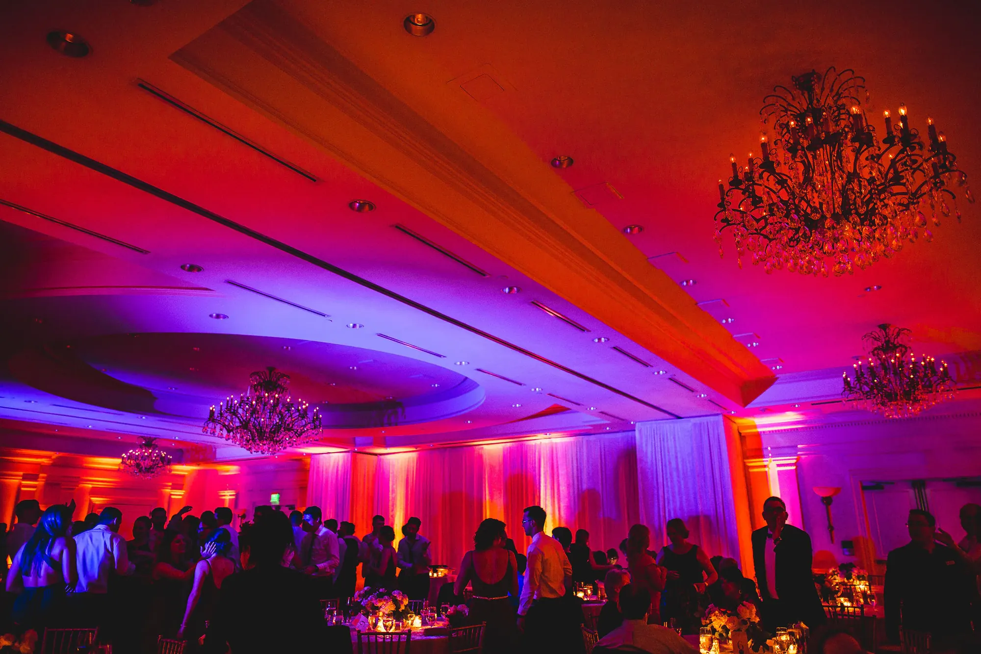 Ballroom with full uplighting and a packed dance floor