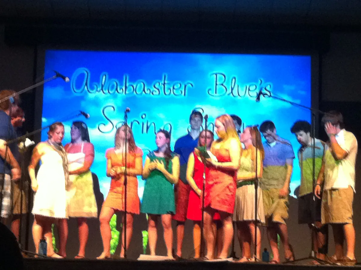 School show on stage with projected title